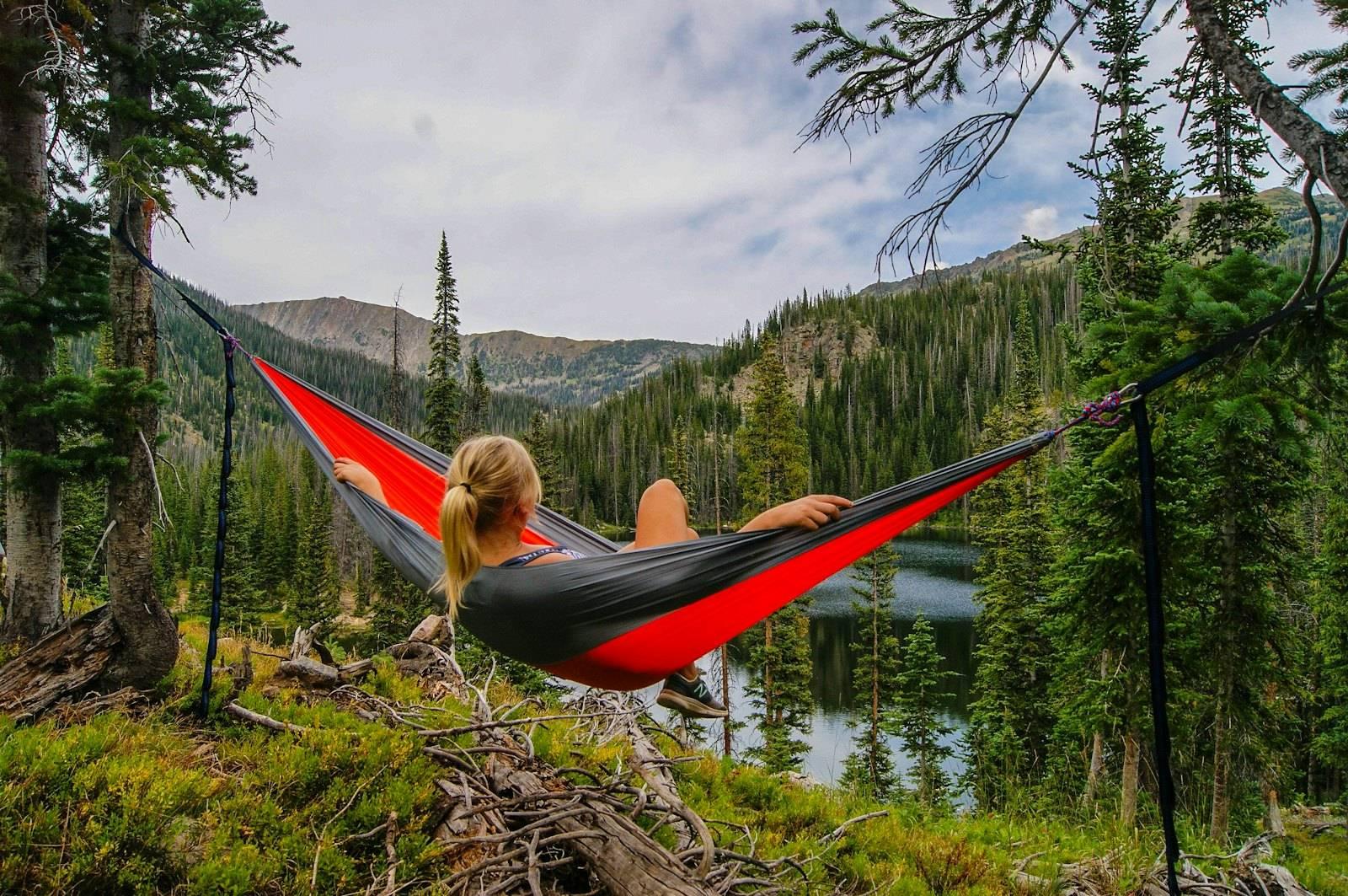 Woman on hammock near to river