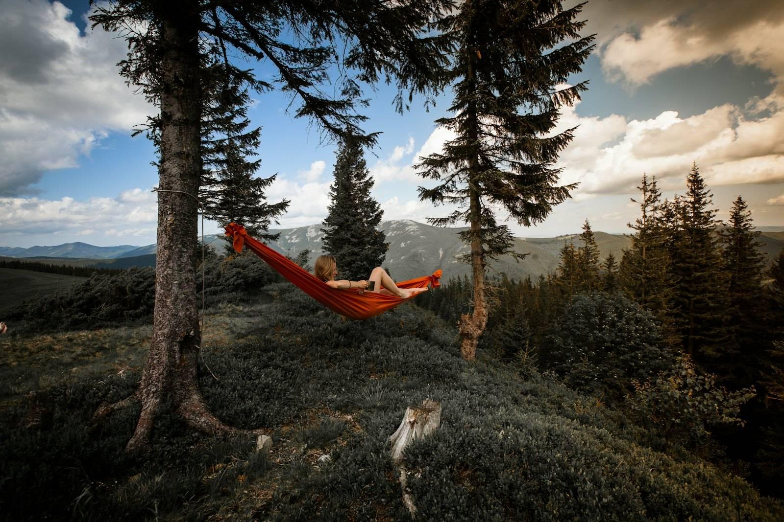 Person lying on red hammock